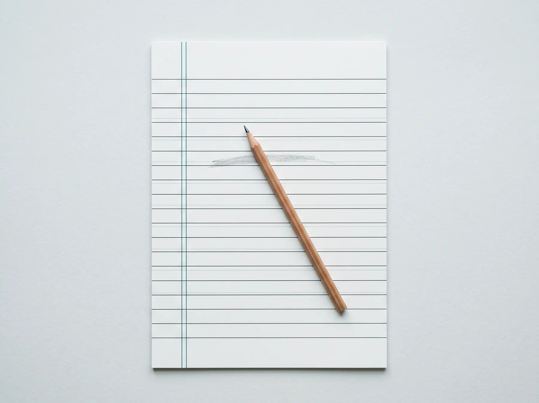 A ruled record sheet and a pencil on a pale desk